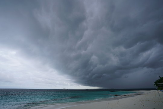 View of the beautiful beach with turquoise colored water during monsoon season in The Maldives