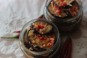 two glass jars with fried eggplants