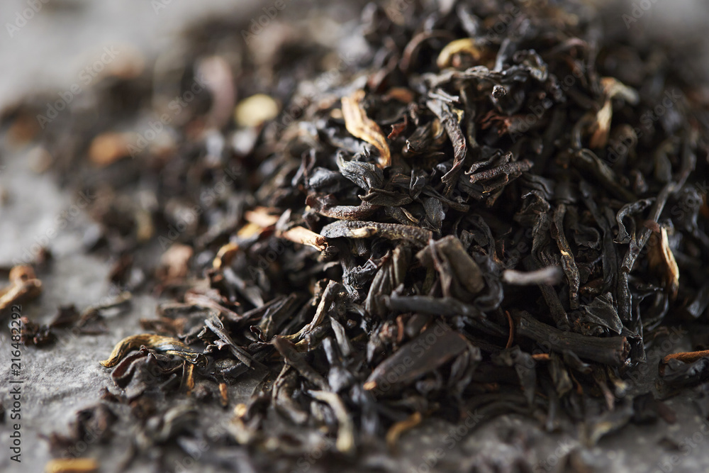 Wall mural black tea leaves background