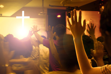 praise and worship concept:Hands raised in excitement and praise at contemporary church concert and bright lights - obrazy, fototapety, plakaty