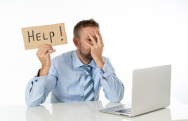 Businessman on laptop and help sign