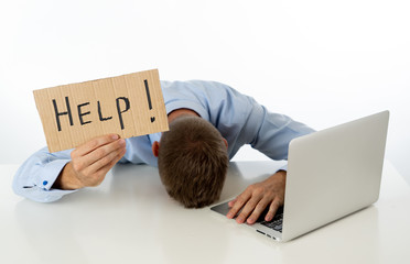 Businessman on laptop and help sign