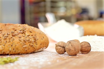 Bread with sunflowers and walnuts on the wood table