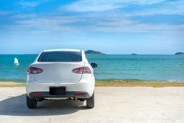 Fototapeta na wymiar White car parking at beautiful sea in sunny day at beautiful sea in sunny day