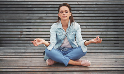 woman practices yoga and meditates in the lotus position