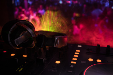 In selective focus of Pro dj controller.The DJ console deejay mixing desk at music party in...