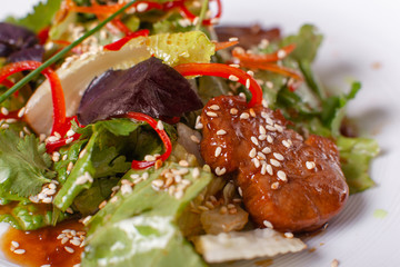 Bowl of salad with beef teriyaki and vegetables. Asian food. Salad on a white dish on table. restaurant menu