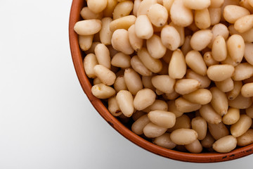 peeled pine nuts on a white acrylic background