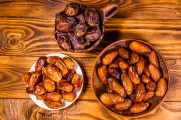 Date fruits on a wooden table. Top view