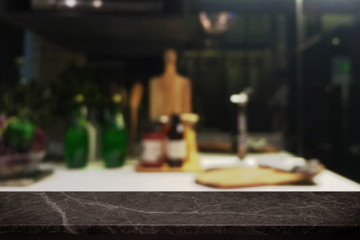 Empty black stone table top and blurred kitchen interior background - can used for display or montage your products.