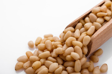 peeled pine nuts on a white acrylic background