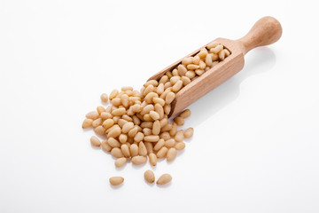 peeled pine nuts on a white acrylic background