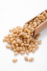 peeled pine nuts on a white acrylic background
