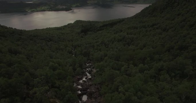 4k Drone footage tilting up on beautiful river in Norway, Sunnmore Orsta, Skorgedalen. Filmed in the summer.