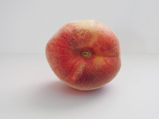 A fragrant peach on the table