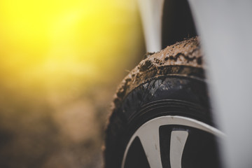 Close up of mud car tires with warm colors.
