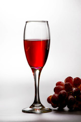 Glass of wine with grape.