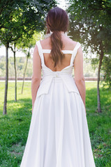 Fototapeta na wymiar Girl standing outside in white dress