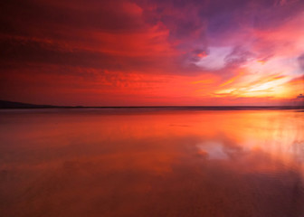 Naklejka na ściany i meble sunrise Seascape with beautiful reflection for background. soft focus due to long expose.