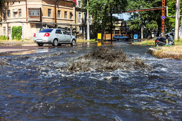Accident sewerage system. Water flows over the road from sewer. Accident in sewer. Breakthrough...