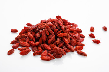 dried goji berries on a white acrylic background