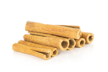Lot of whole dry brown cinnamon stick stack isolated on white background