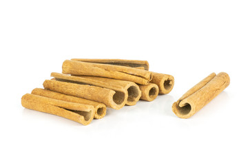 Lot of whole dry brown cinnamon stick heap and one separated isolated on white background