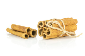 Lot of whole dry brown cinnamon stick tied by jute rope tied by jute isolated on white background