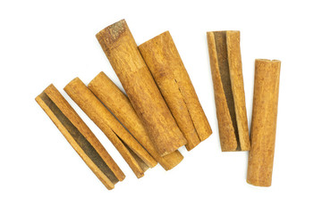 Lot of whole dry brown cinnamon stick flatlay isolated on white background