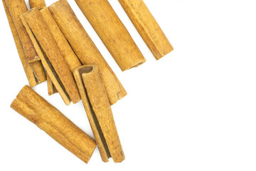 Lot of whole dry brown cinnamon stick flatlay isolated on white background