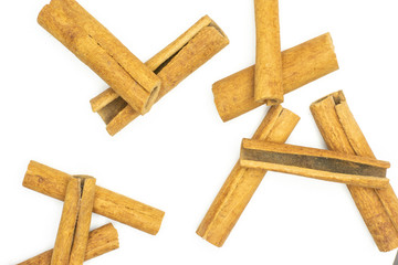 Lot of whole dry brown cinnamon stick flatlay isolated on white background