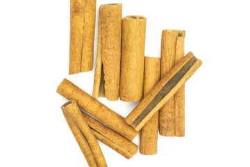 Lot of whole dry brown cinnamon stick flatlay isolated on white background