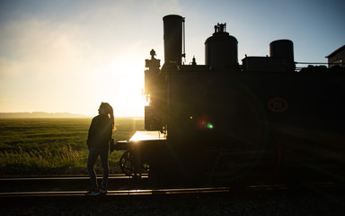 Fototapeta na wymiar Sunset girl and train silhouette