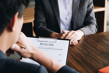 Job interview in office, employer reviewing good cv of prepared skilled applicant, recruiter considering application, hr manager making hiring decision