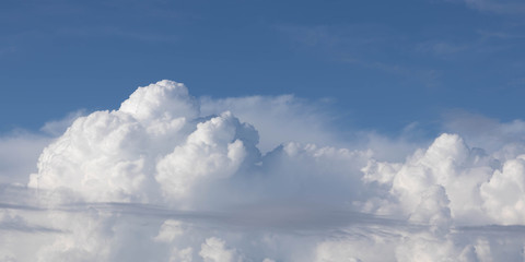 a large clouds on a blue sky