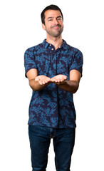 Brunette man holding something on white background