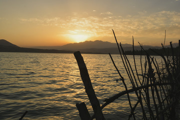 sunset over the mountains, reflection in the water