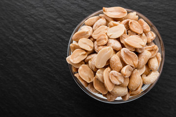 fresh peanuts on a dark stone background