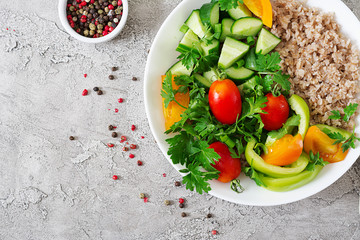 Diet menu. Healthy vegetarian salad of fresh vegetables - tomatoes, cucumber, sweet peppers and porridge on bowl. Vegan food. Flat lay. Top view