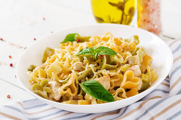 Creamy pasta with chicken and eggplant  served in deep plate. Italian food.