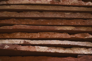 closeup stacked old brick cut tiles