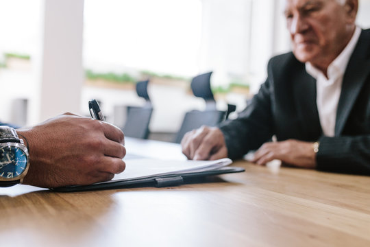 Business people signing contract papers