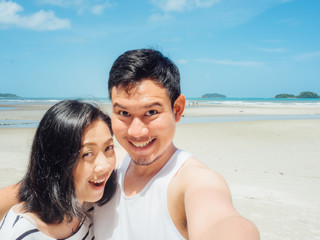 Couple tourist selfie on sunny summer beach.