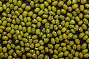 fresh Mung beans on a dark stone background