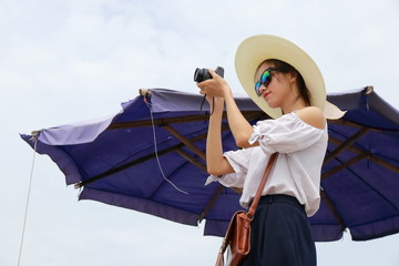 a woman taking photo in beach, Vietnam