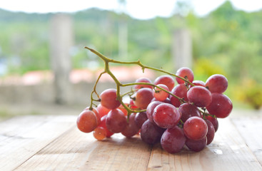 red grapes on wooden table. selective focus.