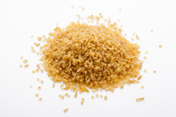 raw bulgur on a white acrylic background