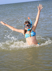 girl of thirteen in a mask for diving into the sea