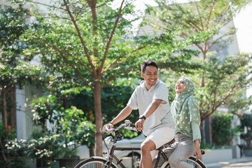 Fototapeta na wymiar woman and man riding a bike