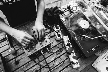 Dj playing music on a vinyl  turntable at the summer party